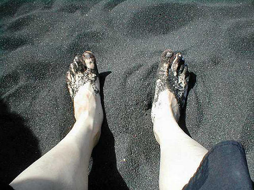 feet in black sand